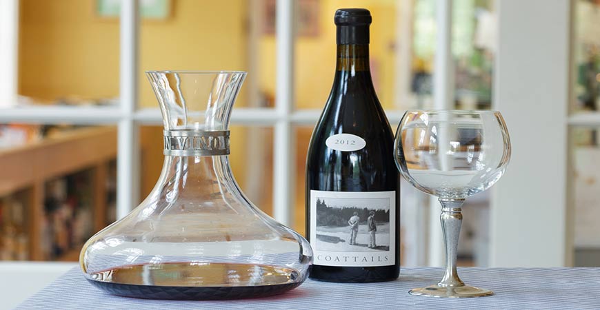 A wine decanter is a unique type of glass to use for a water garden