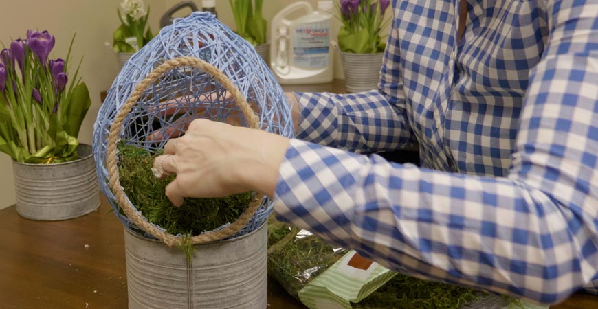 Stuff the basket with faux moss or grass